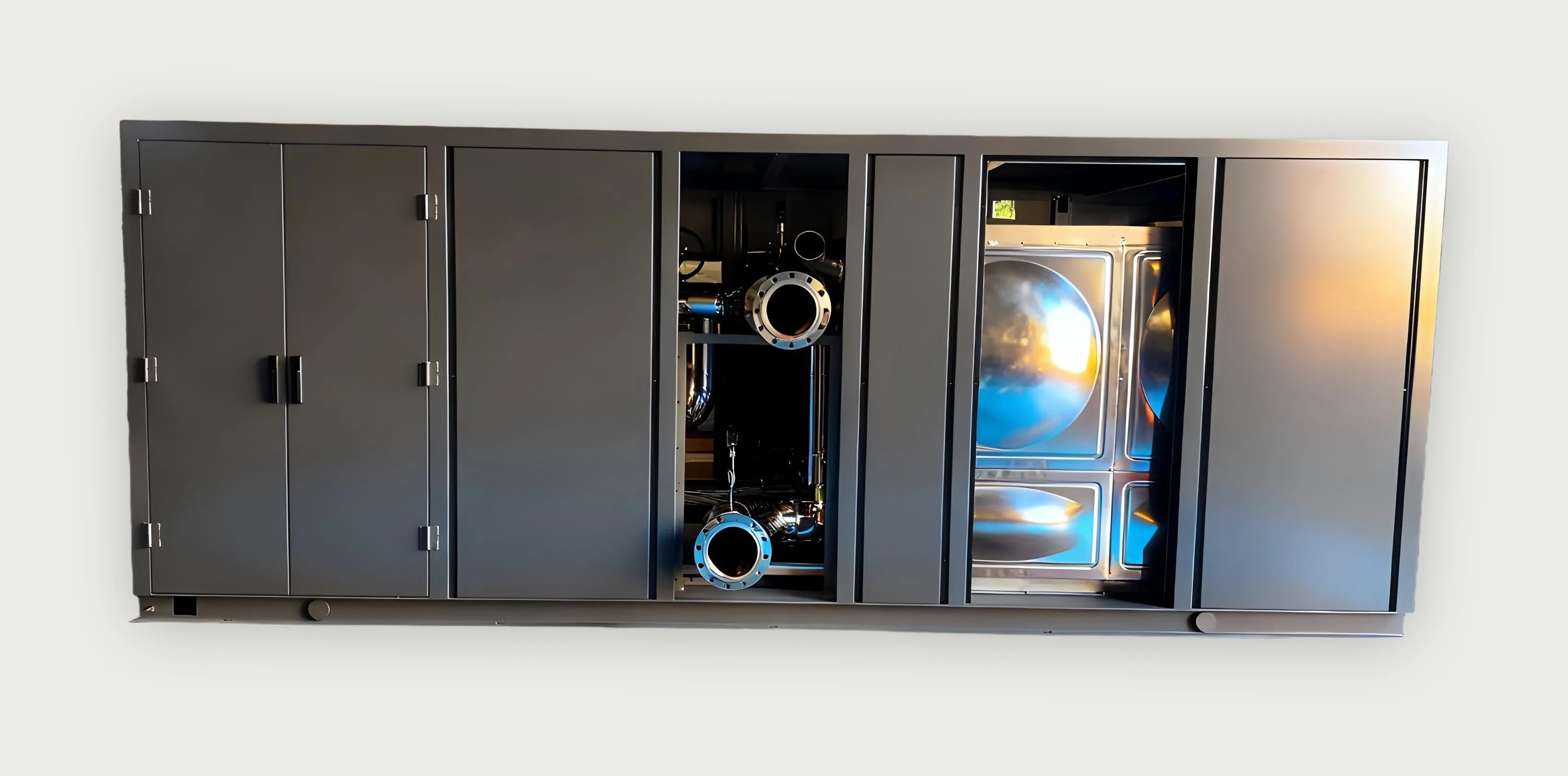 Grey pump-station enclosure with two doors open, showing a stainless storage tank and flanged pipe ends.